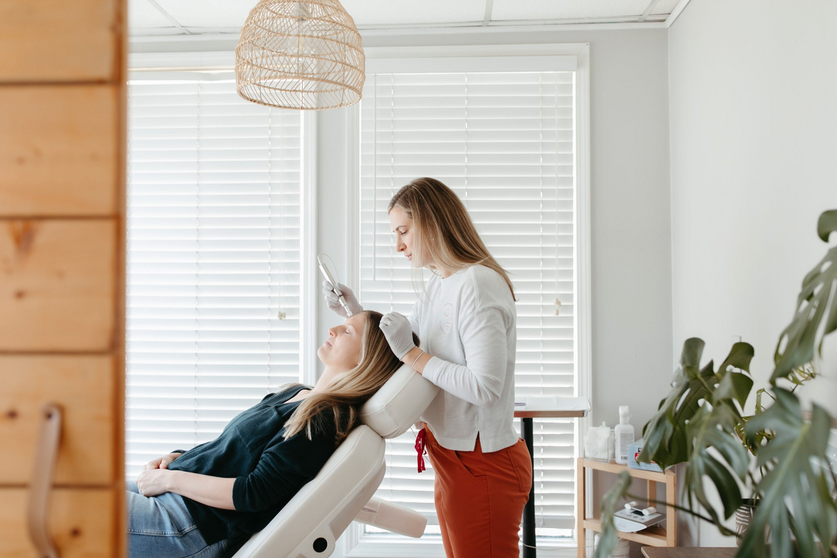 Nurse performing microneedling on forehead at Nuud Skin Co. 